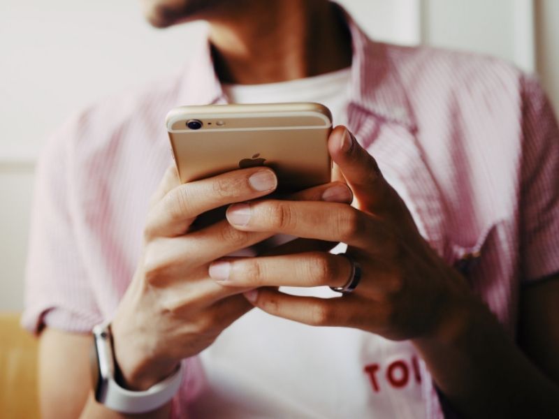 a-man-holds-a-cell-phone-with-an-appointment-booking-app