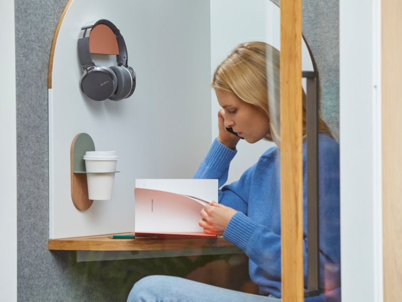 a woman sitting in a booth with boundaries