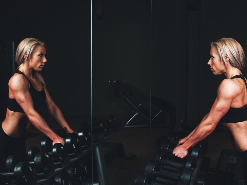 personal trainer with barbells