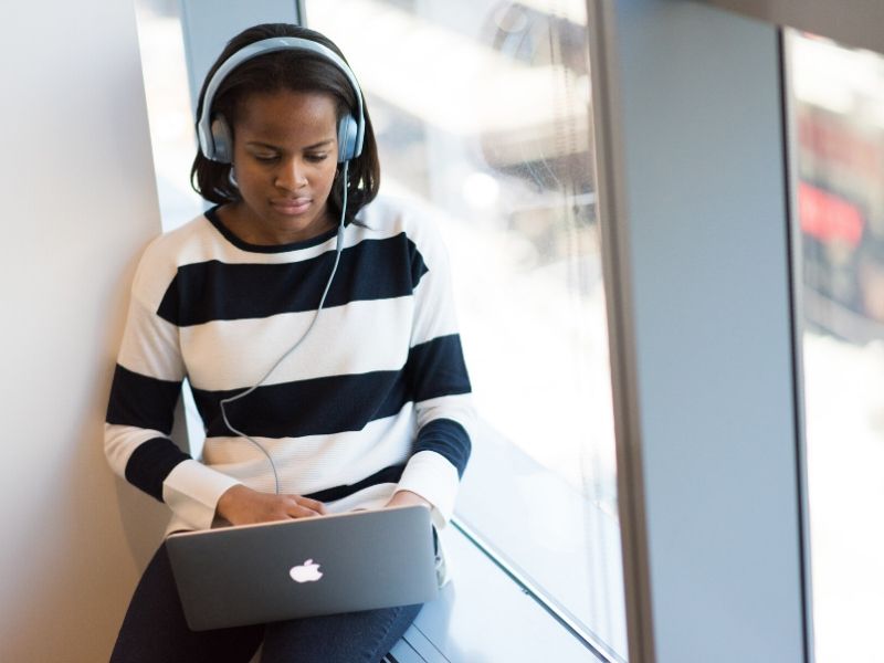 woman working remotely by a window