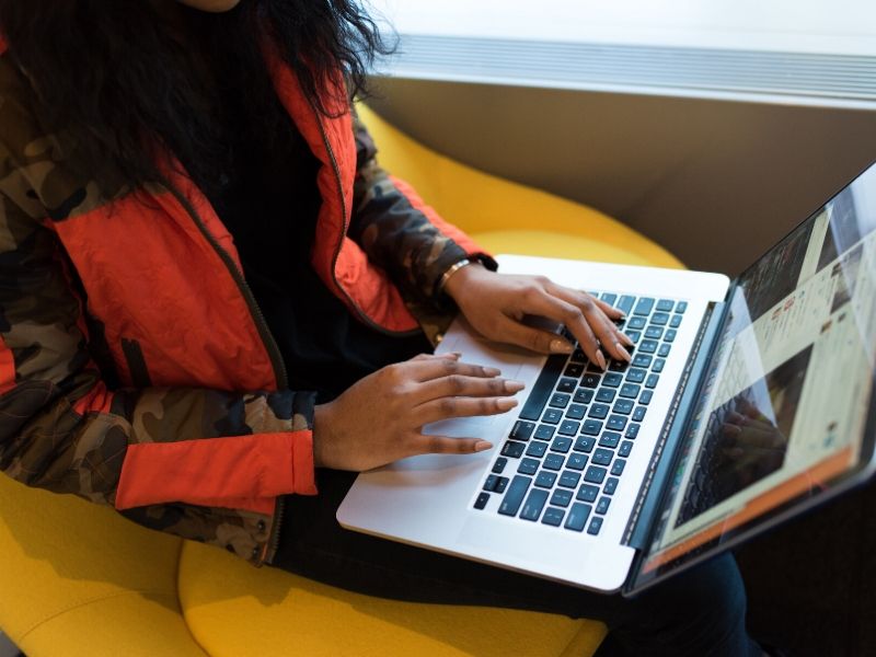 young woman working on virtual appointments on her laptop