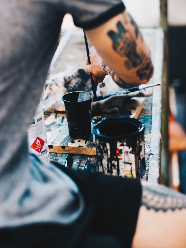 a man is painting on a table